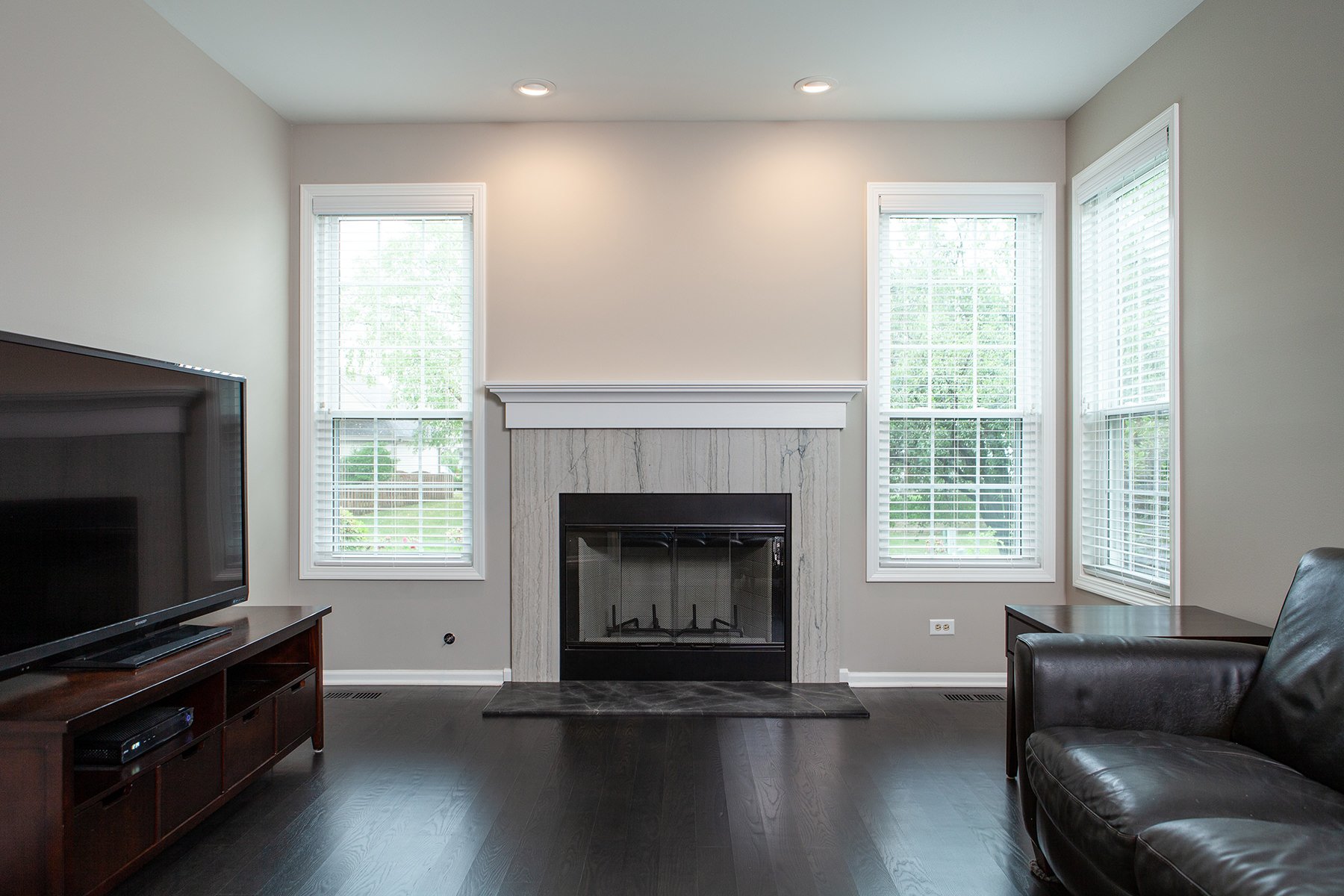 remodeled fireplace with white trim and gray and black stone