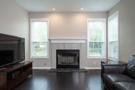 remodeled fireplace with white trim and gray and black stone