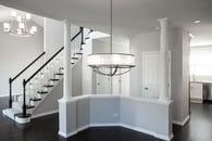 Beautiful modern home remodel in Lake Zurich with natural wood floors, white accents and modern lighting.