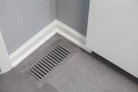 Beautiful modern kitchen remodel in Lake Zurich with natural wood floors and custom floor vent covers.
