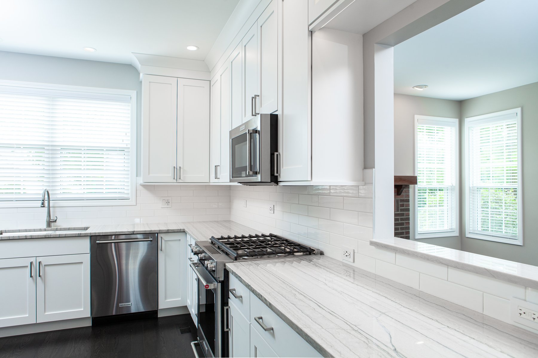 Beautiful modern kitchen remodel in Lake Zurich with natural wood floors and white cabinets.