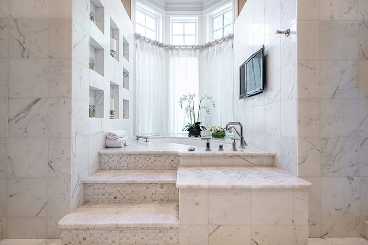 bathroom tub with tile and steps up to a bathroom tub