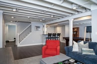 Remodeled basement in Libertyville, Illinois with hardwood floors, pool table, workout room and lounge area.