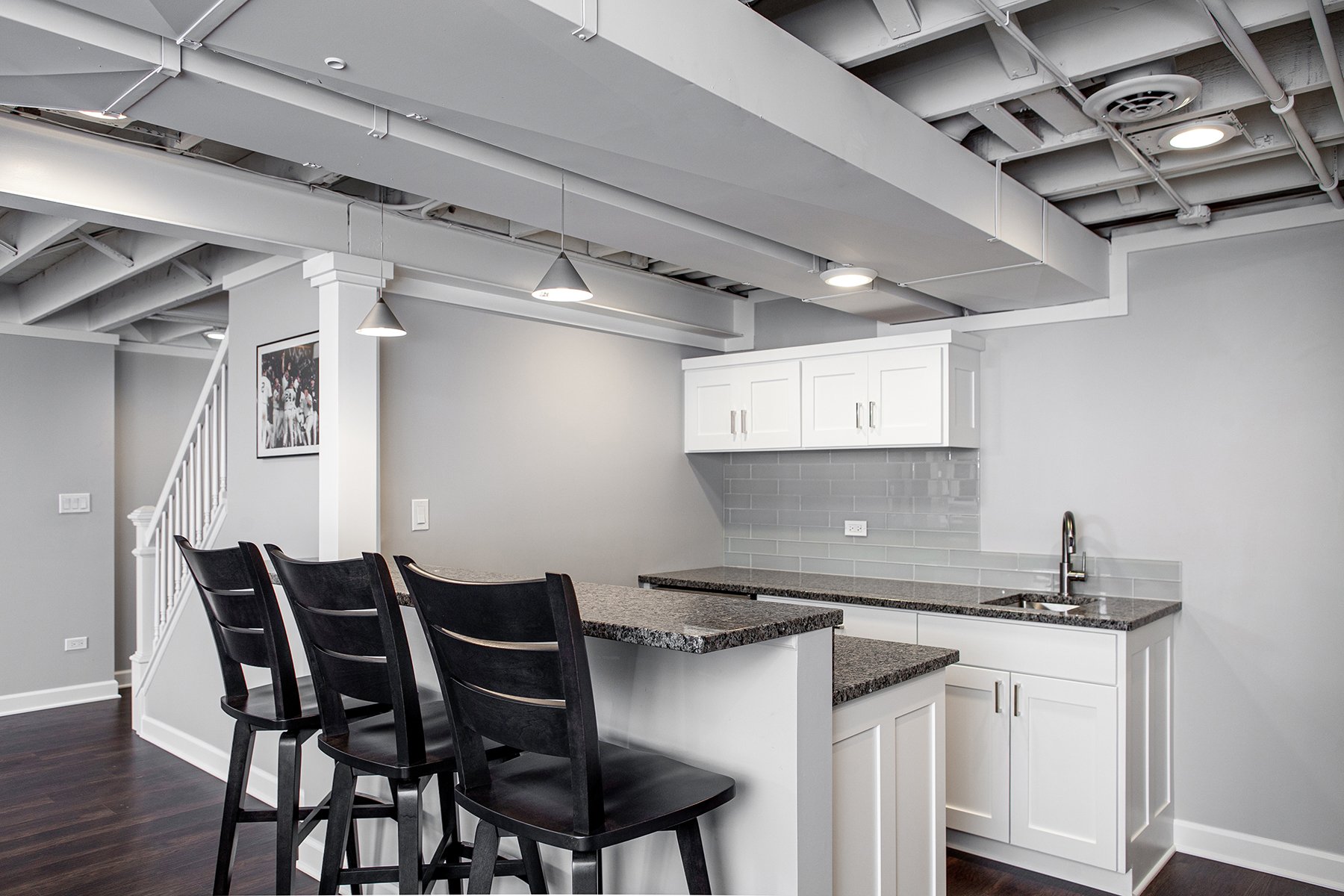 Remodeled basement in Libertyville, Illinois with hardwood floors and kitchen.