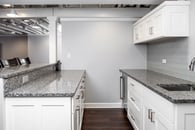 Remodeled basement in Libertyville, Illinois with hardwood floors, pool table, workout room and kitchen.