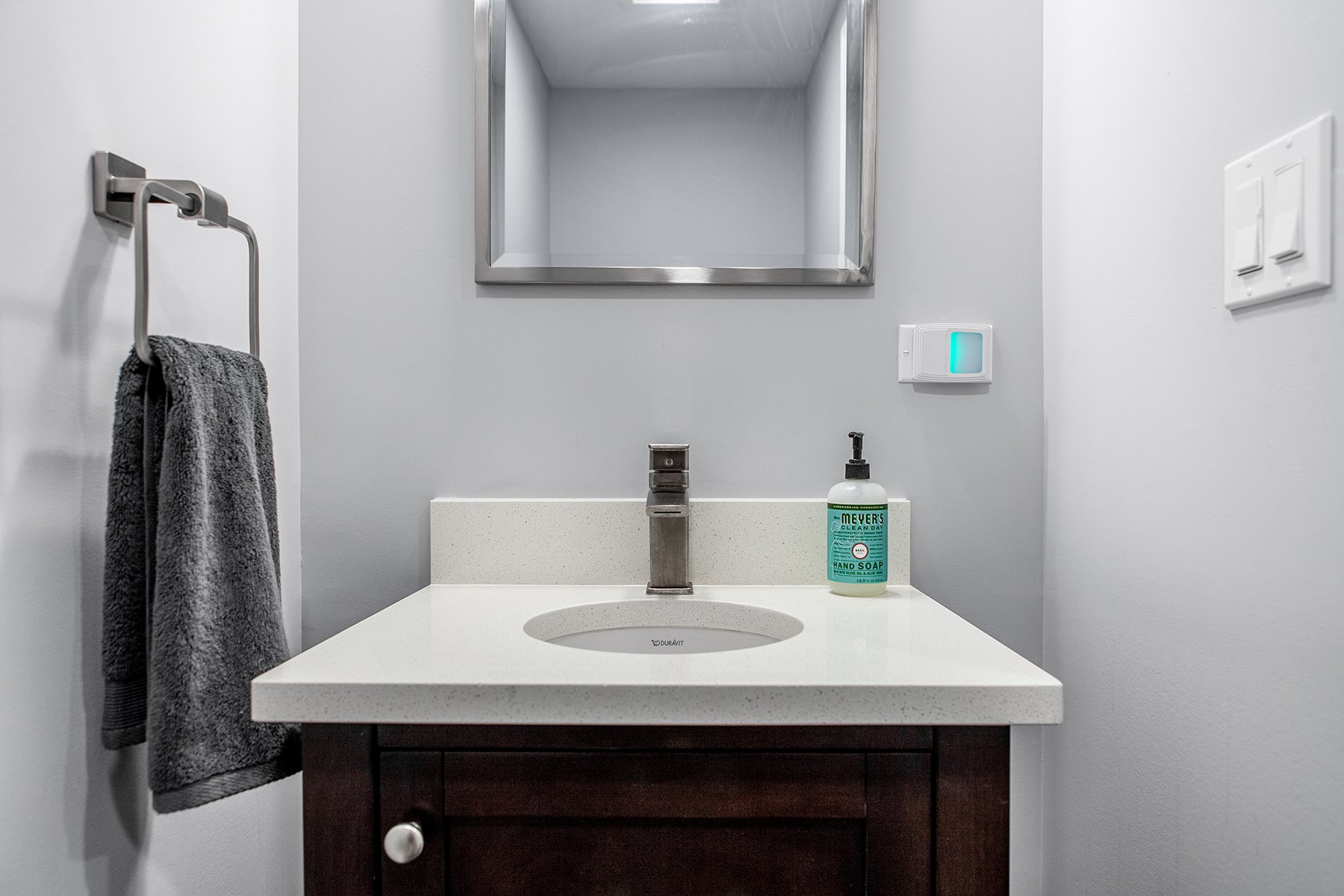 Remodeled basement in Libertyville, Illinois with hardwood floors and small powder room.