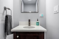 Remodeled basement in Libertyville, Illinois with hardwood floors and small powder room.