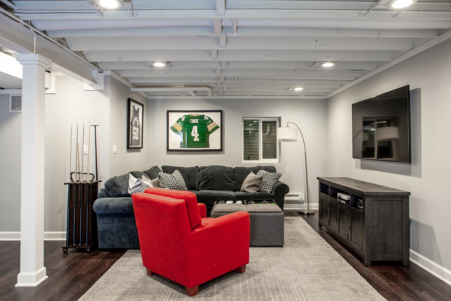 Remodeled basement in Libertyville, Illinois with hardwood floors, pool table, workout room, lounge area and kitchen.