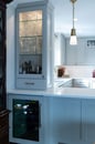 Kitchen renovation with gray painted cabinets, gold hardware, white marble countertops and a backsplash with white subway tile.