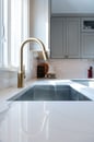 Kitchen renovation with gray painted cabinets, gold hardware, white marble countertops and a backsplash with white subway tile.