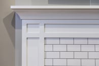 Subway tiled fireplace surround and custom white trim mantle..