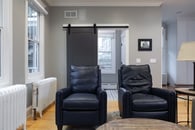 Medium gray walls and light wood flooring make for a classic, yet, modern look in this Libertyville home remodel.
