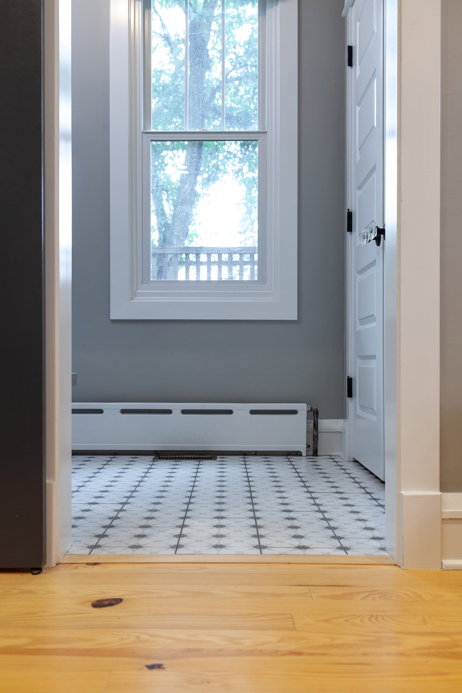 Light wood flooring and modern floor tiles make for a classic-yet modern look.