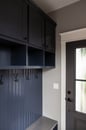 Navy mudroom trim with a beautiful classic black door.