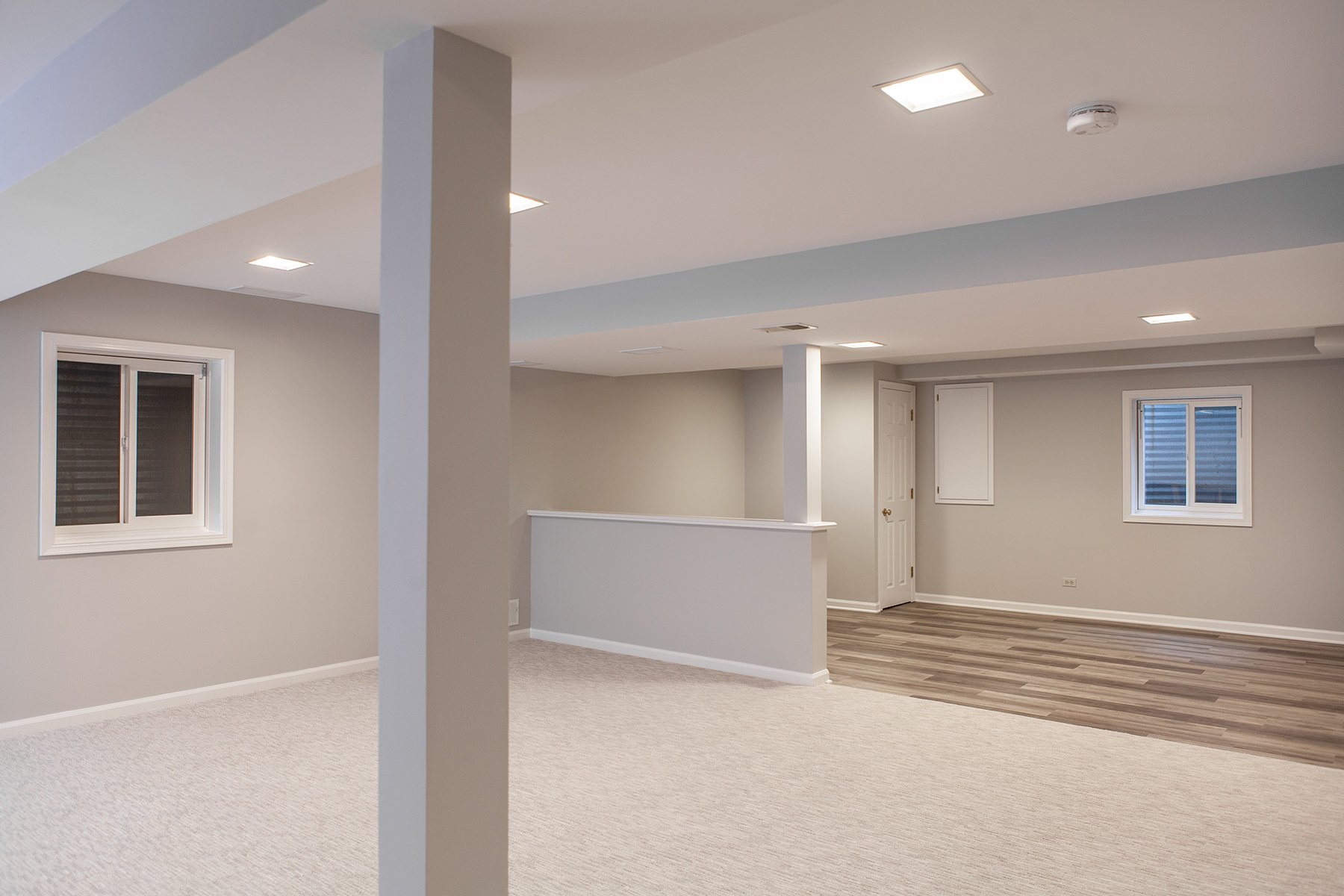 basement remodel with carpet and engineered wood flooring