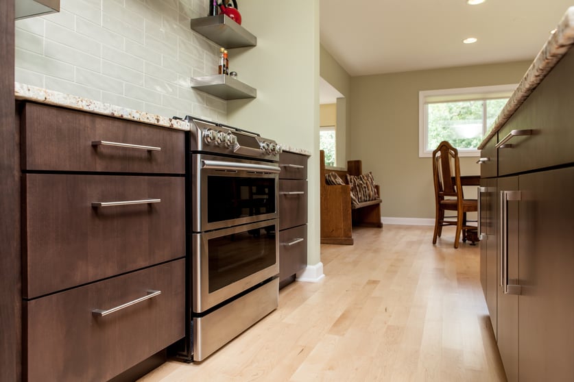 Light hardwood flooring makes a perfect contrast for dark wood cabinets