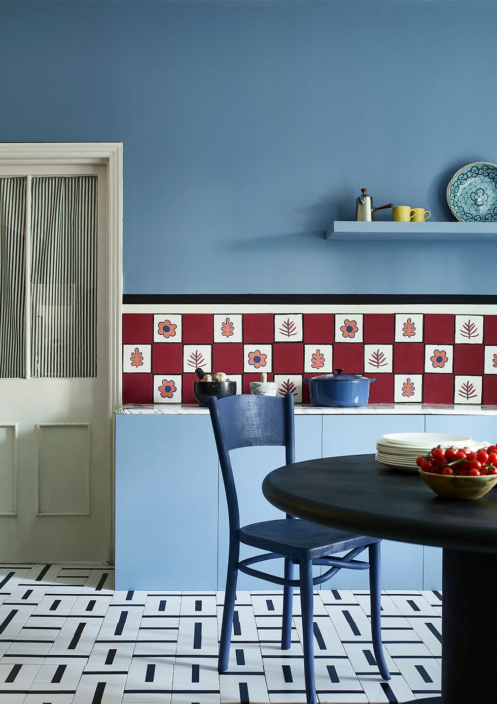 Classic 1950's style kitchen trend with blue geometric tile and light blue painted cabinets.
