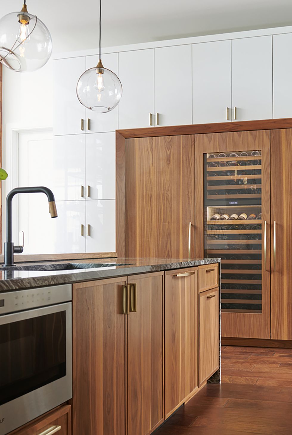 Modern wood cabinets with wooden refrigerator doors and wine refrigerator.