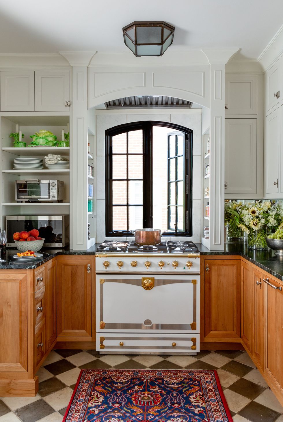 green marble countertops with vintage stovetop and wooden cabinets.