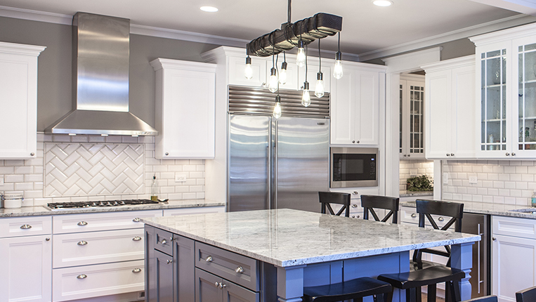 Gray granite kitchen countertops with white cabinets and a slate grey island.