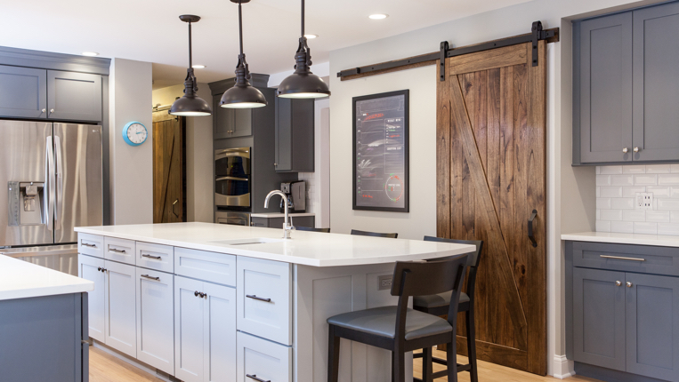 Kitchen island with black lights and white counter-tops