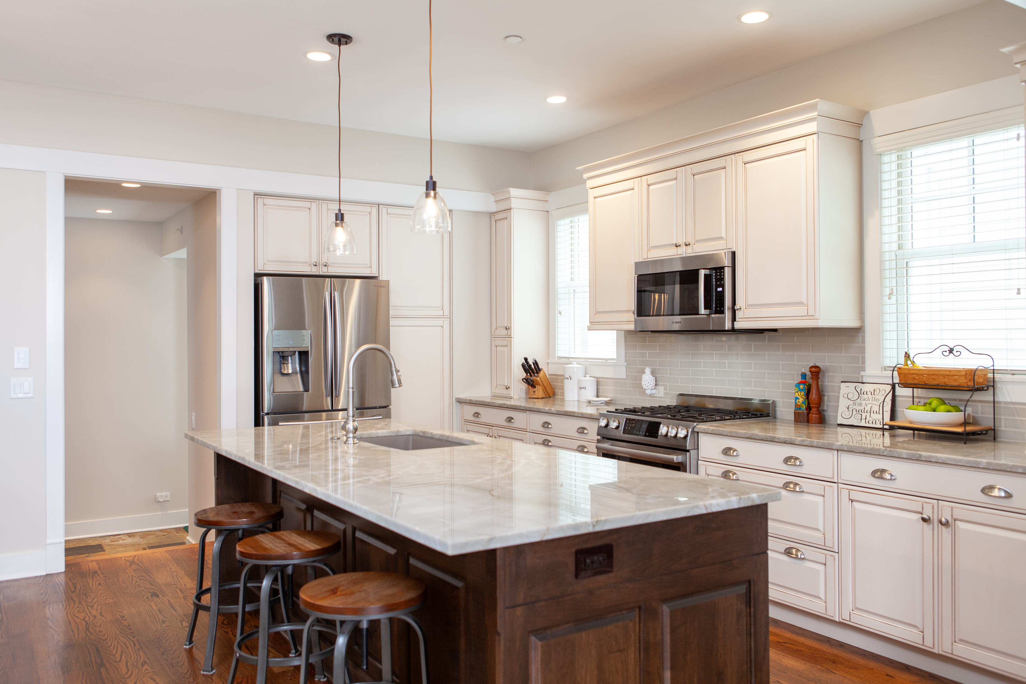 Updated kitchen countertops and cabinets with a large wooden island.