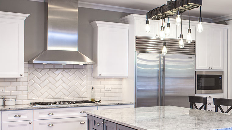 Updated kitchen with herringbone white tiled backsplash