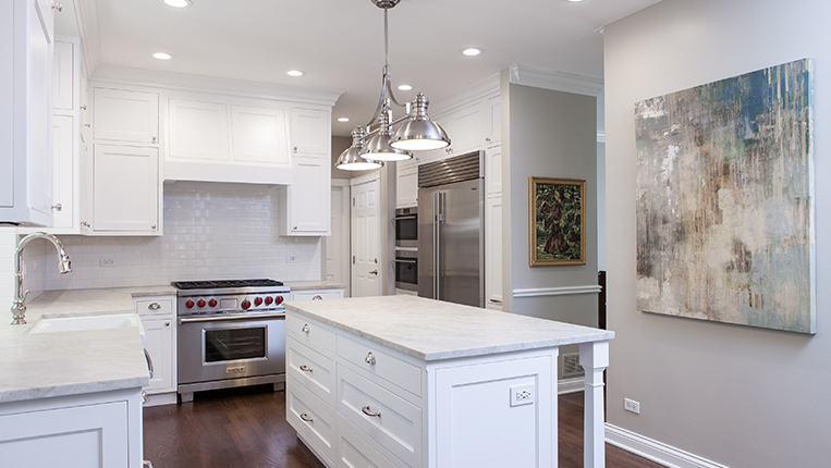 Complete kitchen and home remodel in Libertyville, Illinois. White cabinets and light countertops with kitchen appliances fit for a chef.